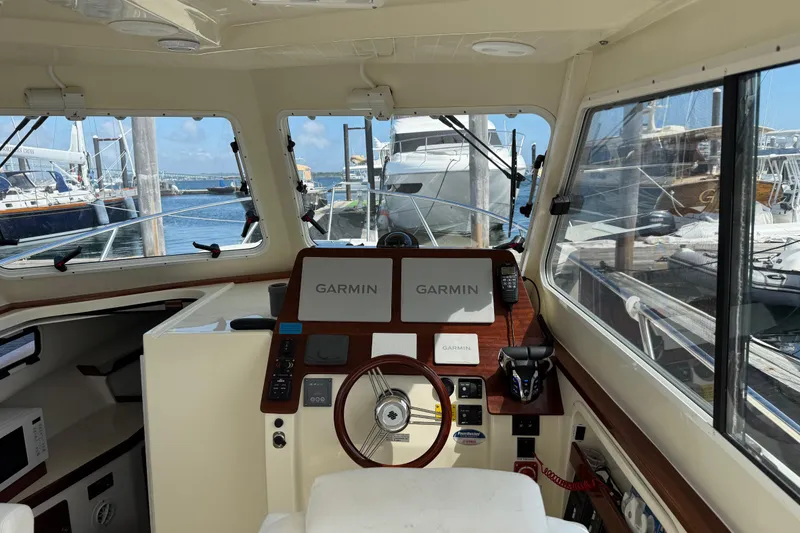 Slide: The Image of Interior view of 2026 NorthCoast 285 HT boat helm with Garmin navigation system. - 6