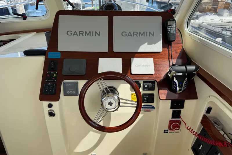 Slide: The Image of Helm of 2026 NorthCoast 285 HT boat with Garmin navigation system and controls. - 7