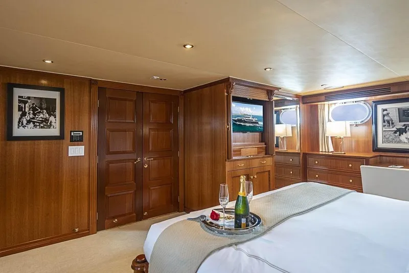 Slide: The Image of Luxurious 2000 Broward Raised Pilothouse yacht bedroom with elegant wood paneling and modern amenities. - 11