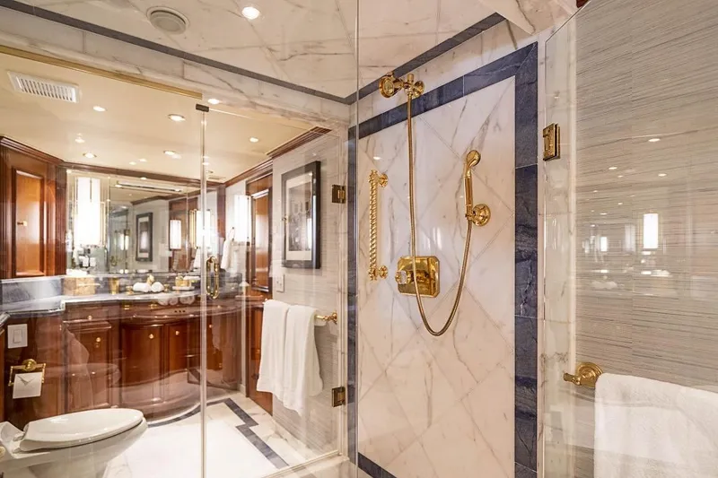Slide: The Image of Luxurious bathroom in 2000 Broward Raised Pilothouse yacht with marble and gold accents. - 13
