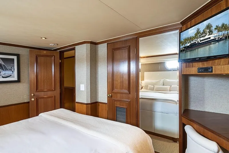 Slide: The Image of Luxurious bedroom interior on 2000 Broward Raised Pilothouse yacht with wood paneling and TV. - 15