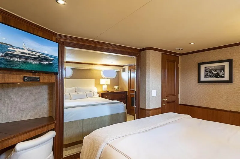 Slide: The Image of Luxurious bedroom interior of 2000 Broward Raised Pilothouse yacht with elegant wood finishes. - 18