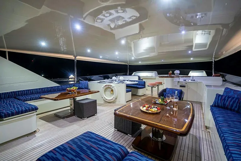 Slide: The Image of Luxurious 2000 Broward Raised Pilothouse yacht deck with elegant seating and dining area. - 21