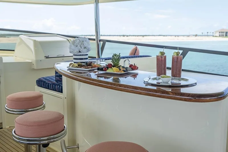 Slide: The Image of Luxurious Broward Raised Pilothouse yacht bar with drinks and fruit platter, ocean view, 2000 model. - 24