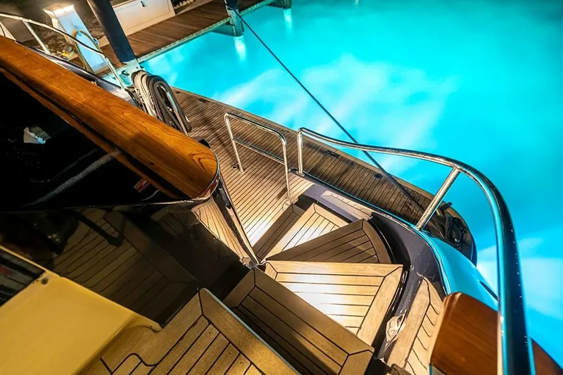 Slide: The Image of Luxurious Broward Raised Pilothouse yacht deck with elegant wooden stairs, 2000 model. - 28