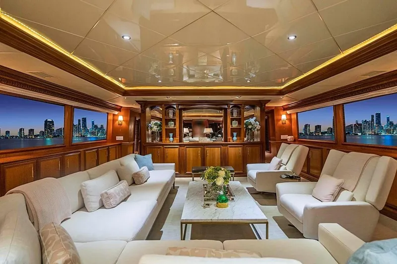 Slide: The Image of Luxurious interior of 2000 Broward Raised Pilothouse yacht with elegant seating and city skyline views. - 3