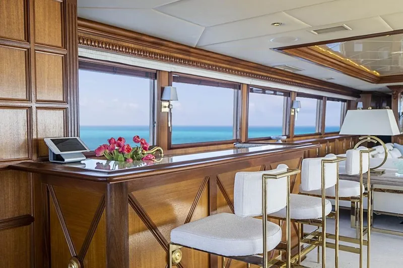 Slide: The Image of Luxurious Broward Raised Pilothouse yacht interior with elegant wood paneling and ocean view, 2000 model. - 4