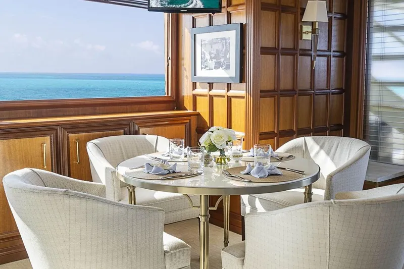Slide: The Image of Elegant dining area on 2000 Broward Raised Pilothouse yacht with ocean view. - 5