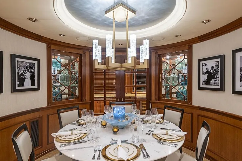 Slide: The Image of Luxurious dining area on 2000 Broward Raised Pilothouse yacht, featuring elegant decor and table setting. - 6