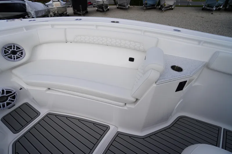 Slide: The Image of 2026 Tidewater 282 CC Adventure boat interior with cushioned seating and cup holder. - 10