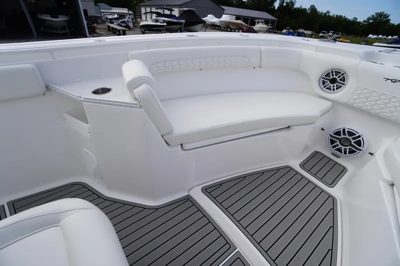 Slide: The Image of 2026 Tidewater 282 CC Adventure boat interior with white seating and marine speakers. - 11
