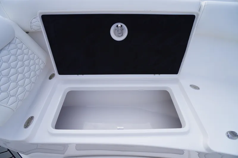 Slide: The Image of Storage compartment on 2026 Tidewater 282 CC Adventure boat, featuring sleek white interior design. - 19