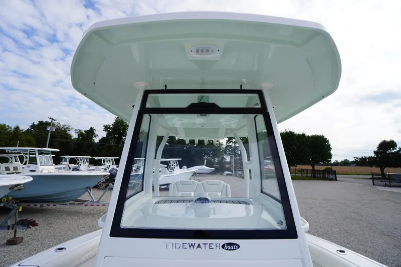 Slide: The Image of 2026 Tidewater 282 CC Adventure boat with sleek design, docked outdoors. - 21