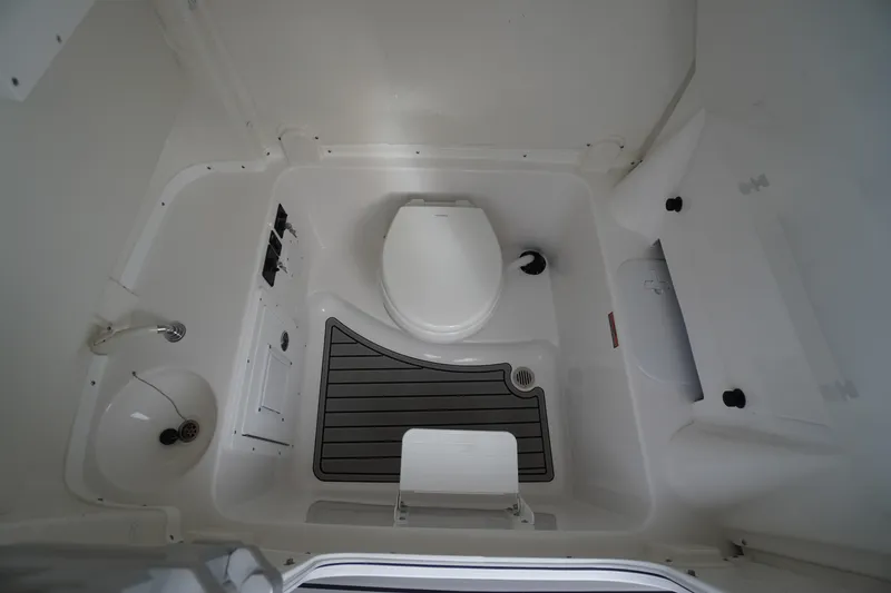 Slide: The Image of 2026 Tidewater 282 CC Adventure boat bathroom interior with toilet and sink. - 26