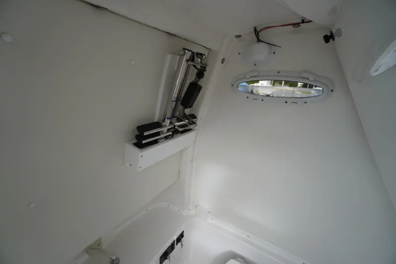 Slide: The Image of Interior of 2026 Tidewater 282 CC Adventure boat, featuring a compact, white cabin space. - 28