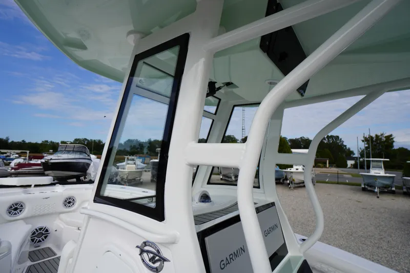 Slide: The Image of 2026 Tidewater 282 CC Adventure boat with Garmin electronics, docked outdoors. - 30