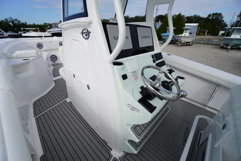 Slide: The Image of 2026 Tidewater 282 CC Adventure boat cockpit with Garmin displays and sleek steering wheel. - 31