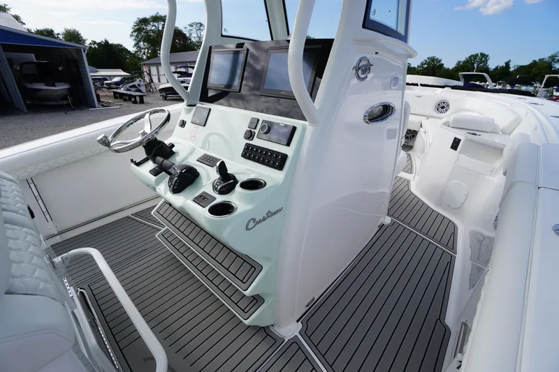 Slide: The Image of 2026 Tidewater 282 CC Adventure boat interior with modern helm and controls. - 32