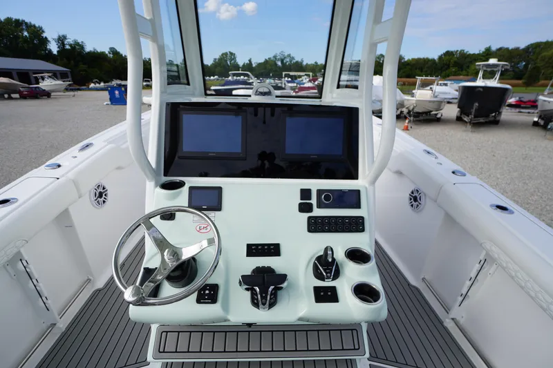 Slide: The Image of 2026 Tidewater 282 CC Adventure boat helm with modern controls and dual screens. - 34
