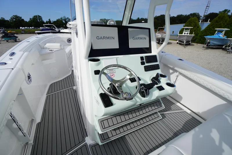 Slide: The Image of 2026 Tidewater 282 CC Adventure boat cockpit with Garmin displays and modern steering wheel. - 35