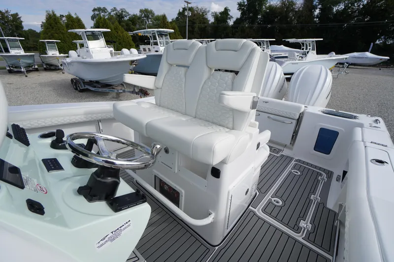 Slide: The Image of 2026 Tidewater 282 CC Adventure boat interior with helm and seating, showcasing modern design. - 41