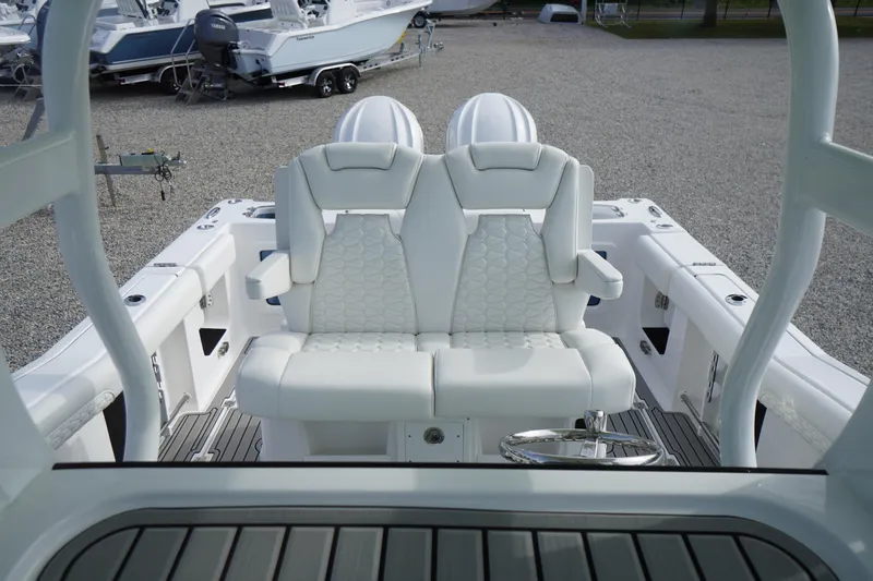 Slide: The Image of 2026 Tidewater 282 CC Adventure boat interior with luxurious white seating and steering wheel. - 42