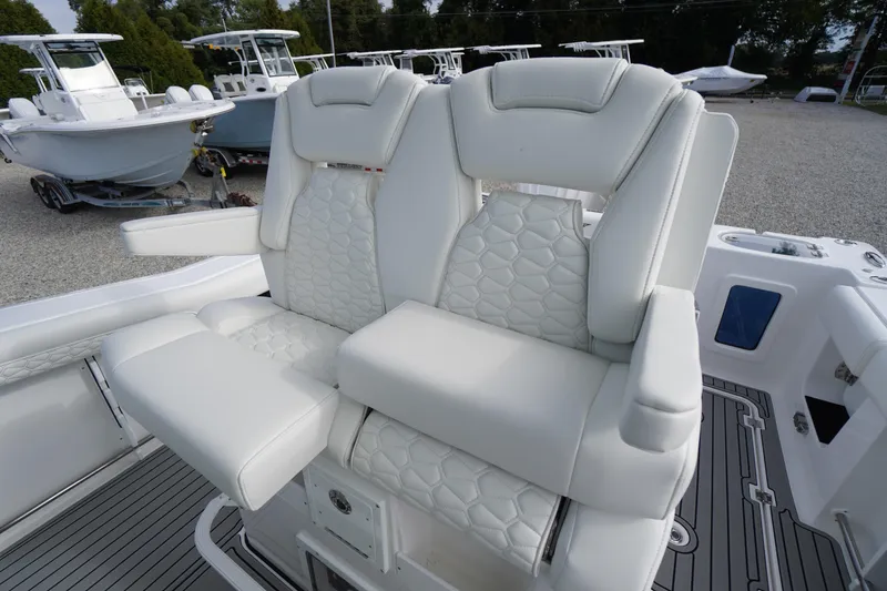 Slide: The Image of Luxurious seating on 2026 Tidewater 282 CC Adventure boat, featuring white cushioned chairs. - 46