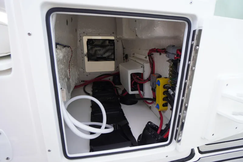 Slide: The Image of Electrical compartment of 2026 Tidewater 282 CC Adventure boat, showcasing wiring and components. - 49
