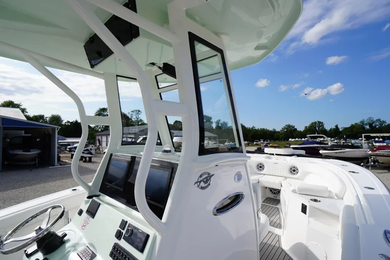 Slide: The Image of 2026 Tidewater 282 CC Adventure boat interior with modern controls and seating. - 51