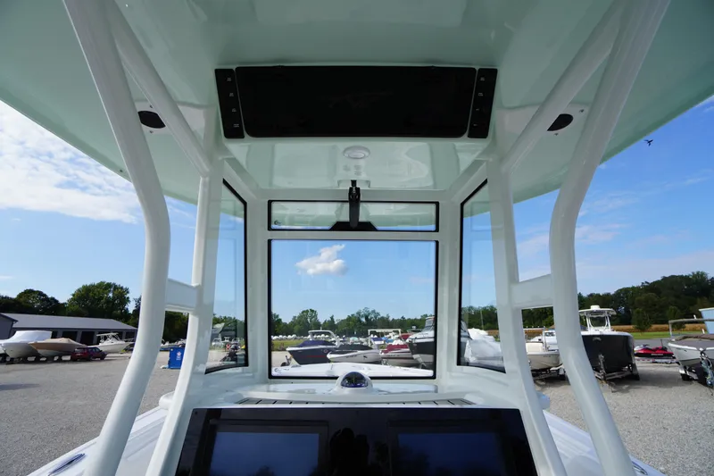 Slide: The Image of 2026 Tidewater 282 CC Adventure boat interior with clear windshield and modern dashboard. - 52