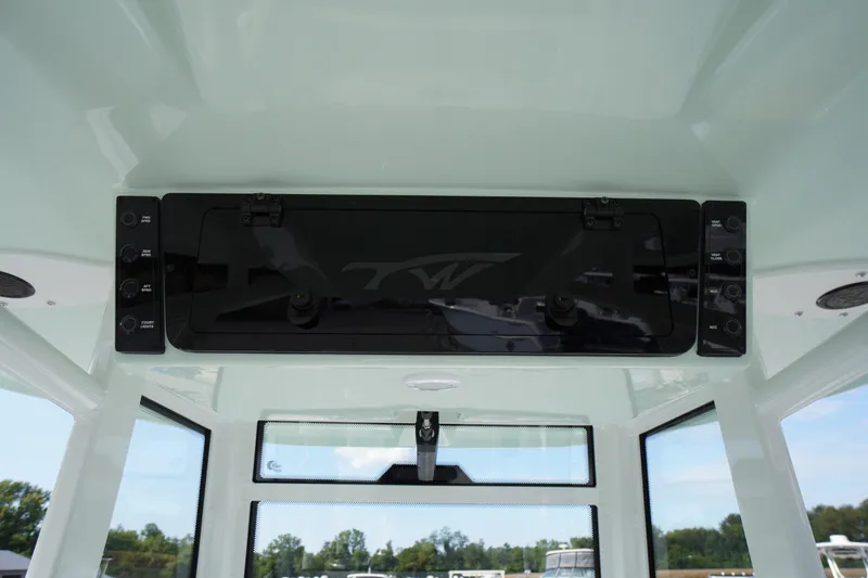 Slide: The Image of Tidewater 282 CC Adventure 2026 boat interior with control panel and windows. - 53