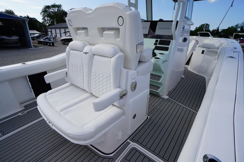 Slide: The Image of 2026 Tidewater 282 CC Adventure boat interior with white cushioned seating and modern dashboard. - 56