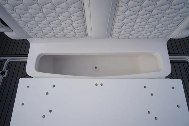 Slide: The Image of Tidewater 282 CC Adventure 2026 boat interior with storage compartment and cushioned seating. - 59