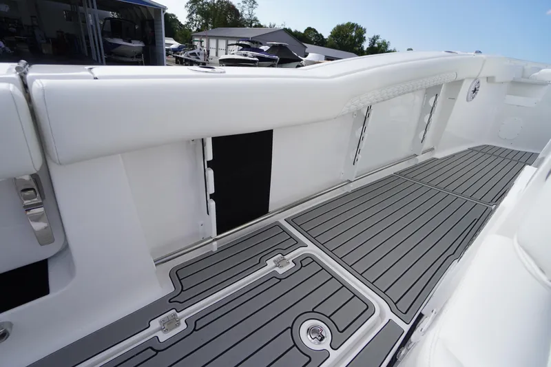 Slide: The Image of 2026 Tidewater 282 CC Adventure boat interior with sleek white seating and gray flooring. - 60