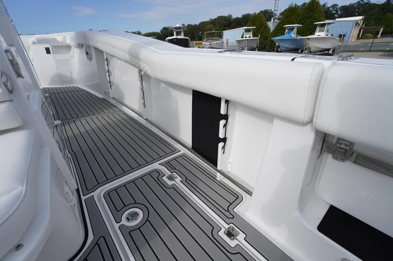 Slide: The Image of 2026 Tidewater 282 CC Adventure boat interior with sleek white seating and modern flooring. - 61