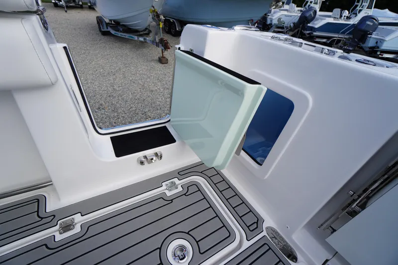 Slide: The Image of 2026 Tidewater 282 CC Adventure boat with open side door and sleek deck design. - 64