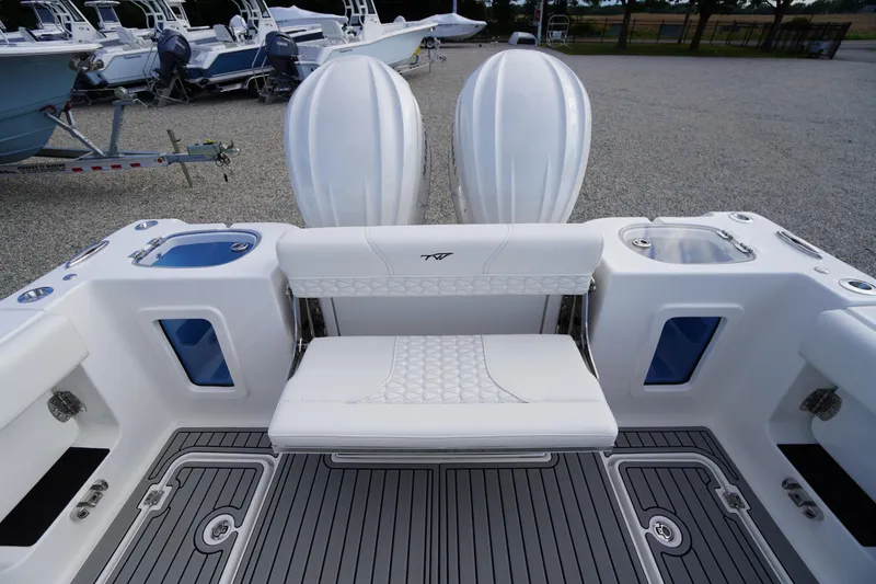 Slide: The Image of 2026 Tidewater 282 CC Adventure boat interior with seating and dual engines. - 71