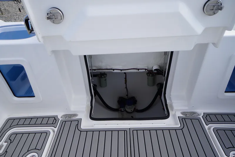 Slide: The Image of 2026 Tidewater 282 CC Adventure boat interior compartment with visible wiring and components. - 74