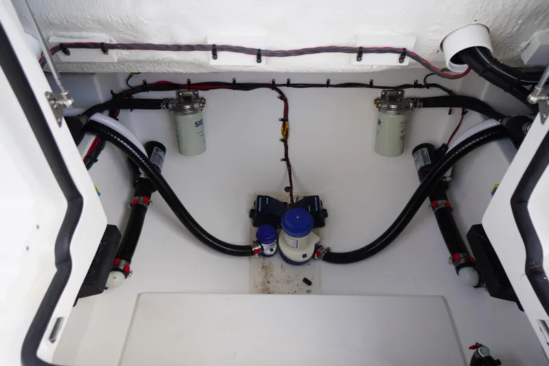Slide: The Image of Engine compartment of 2026 Tidewater 282 CC Adventure boat, showcasing fuel filters and hoses. - 76