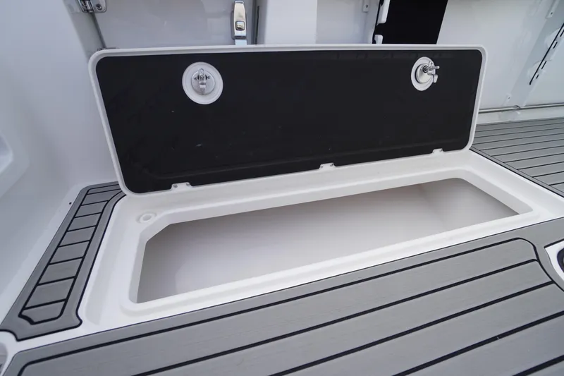 Slide: The Image of Open storage compartment on 2026 Tidewater 282 CC Adventure boat deck. - 79