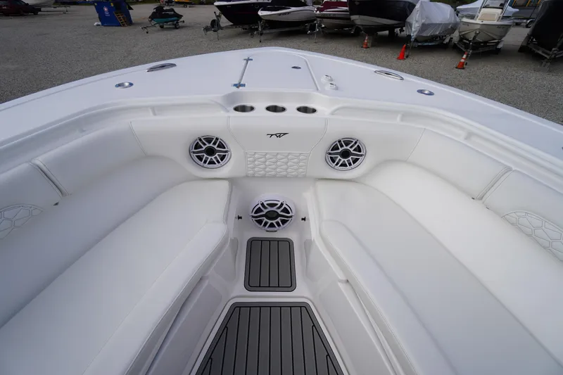 Slide: The Image of 2026 Tidewater 282 CC Adventure boat interior with white seating and speakers. - 8