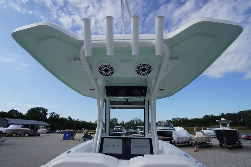 Slide: The Image of 2026 Tidewater 282 CC Adventure boat with T-top and Garmin electronics, docked outdoors. - 81