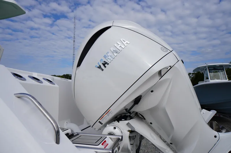 Slide: The Image of 2026 Tidewater 282 CC Adventure boat with Yamaha outboard motor under a cloudy sky. - 87