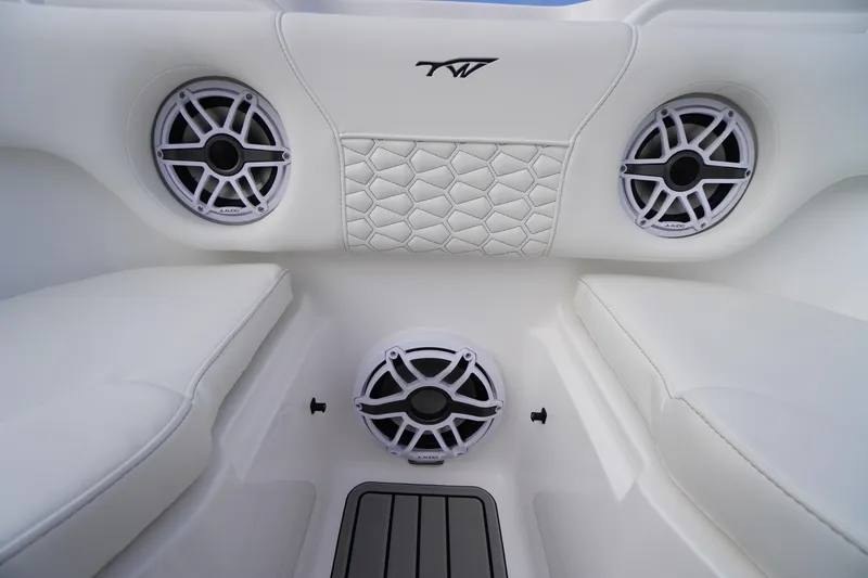 Slide: The Image of 2026 Tidewater 282 CC Adventure boat interior with speakers and cushioned seating. - 9