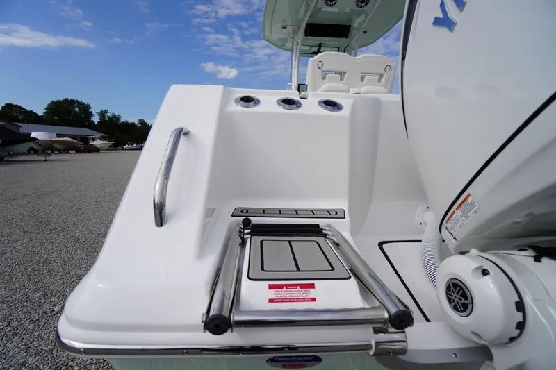 Slide: The Image of 2026 Tidewater 282 CC Adventure boat with swim ladder and Yamaha engine. - 90