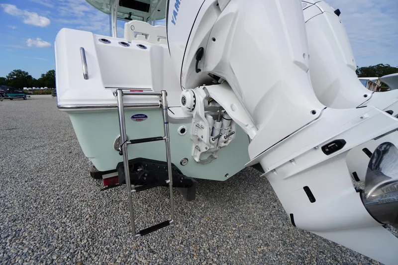 Slide: The Image of 2026 Tidewater 282 CC Adventure boat with Yamaha outboard engines and swim ladder. - 91