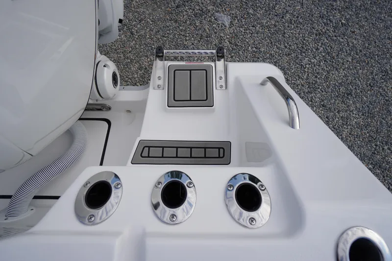 Slide: The Image of 2026 Tidewater 282 CC Adventure boat deck with rod holders and control panel. - 92