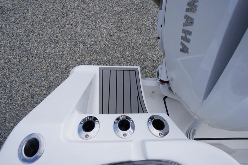 Slide: The Image of 2026 Tidewater 282 CC Adventure boat deck with Yamaha engine and rod holders. - 93