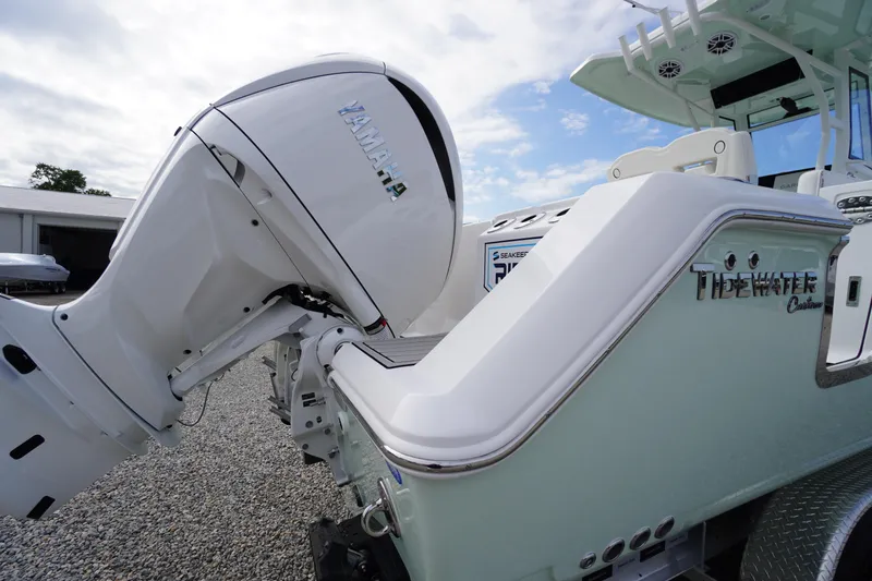 Slide: The Image of 2026 Tidewater 282 CC Adventure boat with Yamaha outboard motor, rear view. - 94