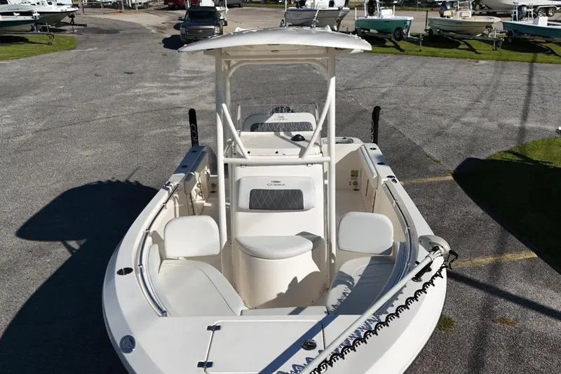 Slide: The Image of 2022 Cobia 201 Center Console boat in a marina setting. - 10